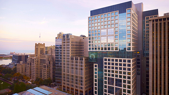 Aerial view of Lurie Children's Hospital with Lake Michigan in view, at sunrise